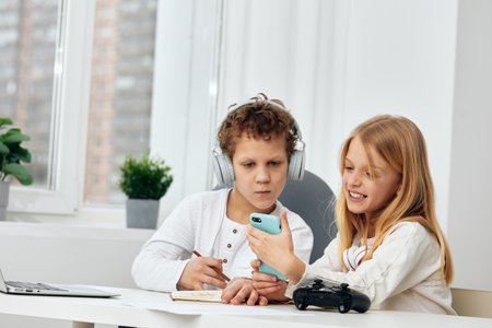Smiling Teenagers Playing Online Games and Taking Selfies with Smartphones at Homeの写真素材