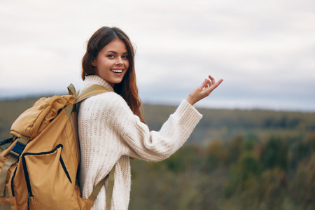 Mountain Adventure: Smiling Woman on Cliffの写真素材