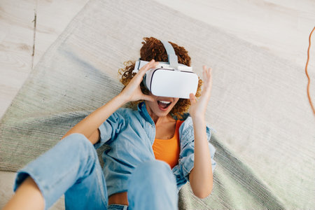 Virtual Reality Joy: Female Person Enjoying Futuristic VR Game at Home, Indoorsの写真素材