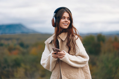Mountain Wanderer: Woman on Phone Capturing the Freedom of Natures Adventure.の写真素材