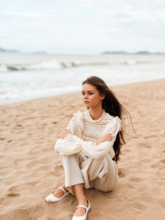 Beauty of the Beach: A Captivating Summer Portrait of a Young Attractive Woman Enjoying the Serenity of Nature and the Relaxation of the Seaの写真素材