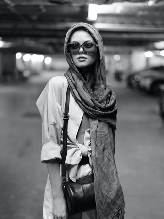 Stylish Lady in Urban Beauty: Fashionable Woman Posing with Elegance and Glamour against City...