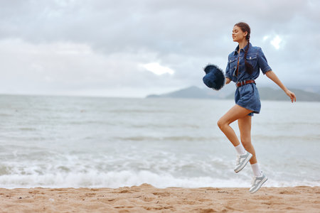 Active Summer: Fit Female Runner Training on the Beach at Sunset, Enjoying the Healthy Lifestyle and Beautiful Nature Surroundingsの写真素材