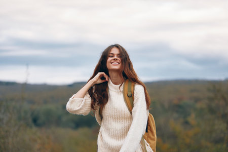 Smiling Woman on Mountain Adventure: A Happy Backpacker Enjoying the Freedom and Nature on a...