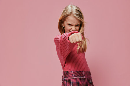 Happy Schoolgirl with Stylish Pink Fashion and a Beautiful Smile in a Studio Portrait â€“ A...