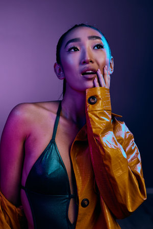 Trendy woman blue lips elegant beauty disco light neon slim fashion colorful purpleの写真素材