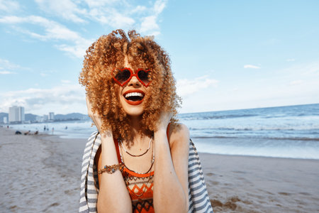 Summer Bliss: Smiling Woman Enjoying Freedom and Joy on the Beachの写真素材