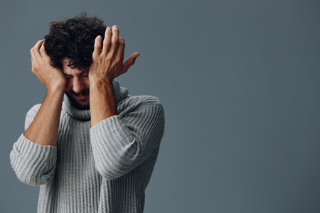 Portrait man face hand depressed adult young sad person stress expression unhappy guy maleの写真素材