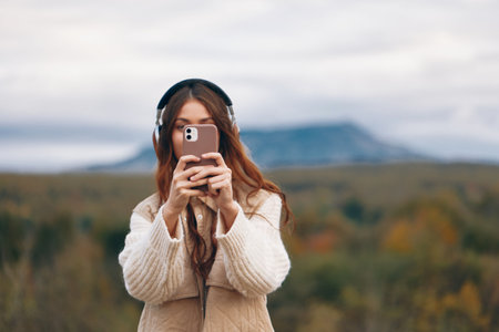 Mountain Womans Phone Call: Smiling Adventure in Nature.の写真素材