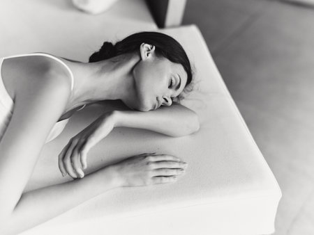 Cozy Joy Happy Woman Resting on a Warm Sofa at Home, Enjoying a Moment of Relaxation Her Black and White Portrait Reflects Her Natural Beauty and Calmness With a Cute Sweater and a Joyful Smile, Sheの写真素材
