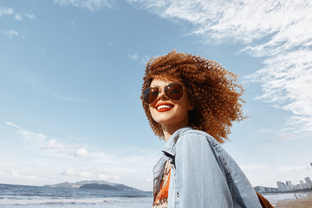 Joyful Ethnicity: A Smiling Afro Lady Enjoying Freedom and Happiness in the Sunny City Streetの写真素材