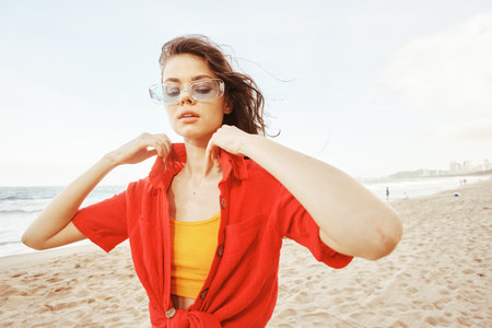 Smiling Woman by the Sea, Embracing Freedom in Colorful Sunglasses: A Trendy Lifestyle Portraitの写真素材