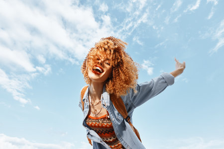 Beach Bliss: A Smiling Woman Dancing with Joy, Backpacking through Natures Freedomの写真素材
