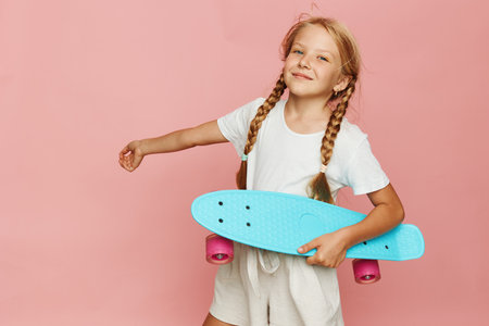 Young Girl Holding Skateboard Posing Smiling