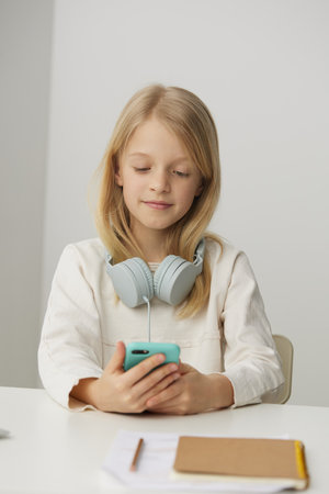 Smart Learning Happy teenage girl studying at home with her laptop, immersed in elearning She is...