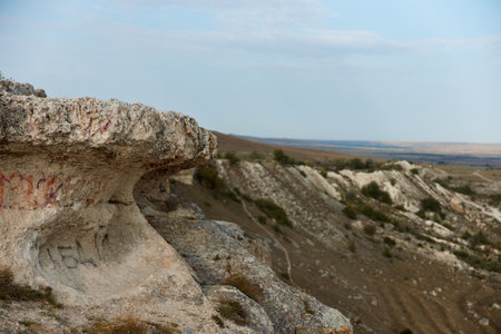 Rock graffiti artwork in remote rocky landscape travel exploration journey adventure discovery nature beauty conceptの写真素材