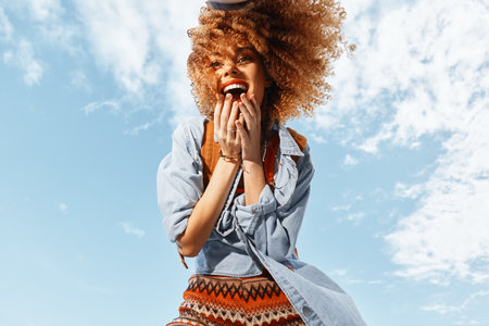 Smiling Woman with Backpack Dancing on Beach, Experiencing Freedom and Joy in a Wide Angle Summer...