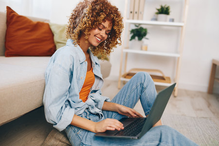 Smiling Woman Freelancing on Laptop in Cozy Living Room, Embracing Modern Technology for Online Work