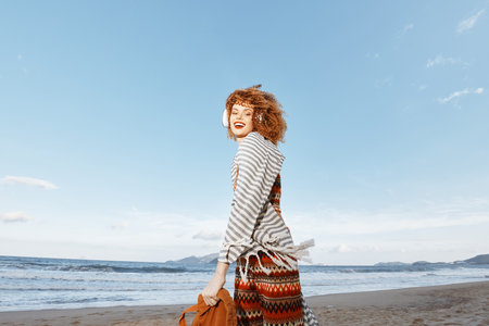 Summer Bliss: A Smiling Woman Enjoying Vacation Freedom on the Beachの写真素材