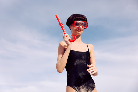 Red Fashion: Smiling Woman Snorkeling with a Tropical Vacation Lifestyleの写真素材