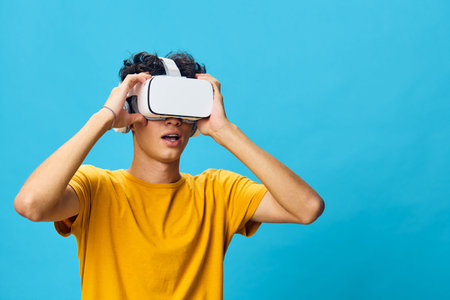 Virtual Reality Experience, Young Man Wearing VR Headset, Engaging in Technology, Bright Blue...