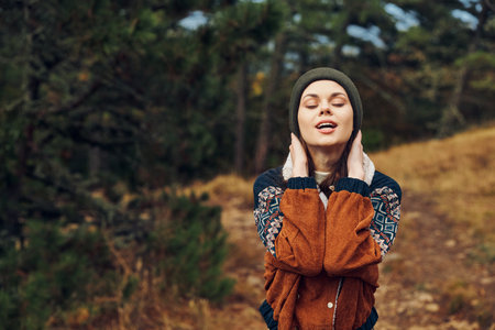 Desperate woman standing in the middle of a field with hands on head feeling lost and overwhelmed by natures beautyの写真素材