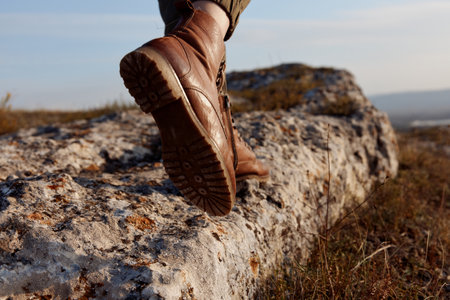 Brown shoes on rock in field for adventure and travel concept in nature environmentの写真素材