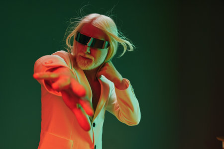 Futuristic man in stylish suit with sunglasses reaching out against a colorful background