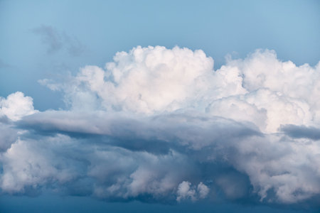 Aerial view of a commercial airplane flying through a dramatic cloudy sky on a travel journey above...