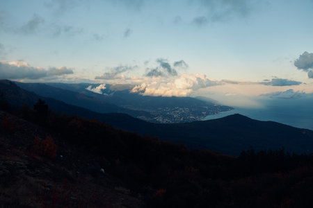 Scenic Mountain Top View with Lush Trees and Clouds in the Sky A Breathtaking Nature Journey Experienceの写真素材