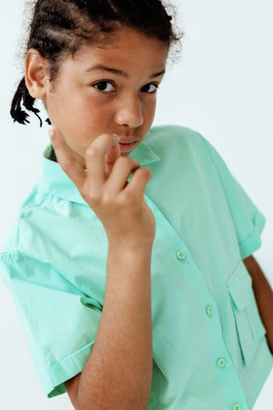 happy young boy in green shirt making peace sign gestureの写真素材