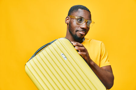 travel, suitcase, man, yellow, summer, sunglasses, enjoyment, lifestyle, adventure, modern, casual, pose, expression, vibrant, cheerful, background, vacation, holiday, tour, exploration, airport, fashionの写真素材