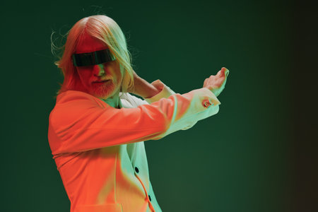 Futuristic man in a stylish outfit on a vibrant background, showcasing modern fashion and technology...
