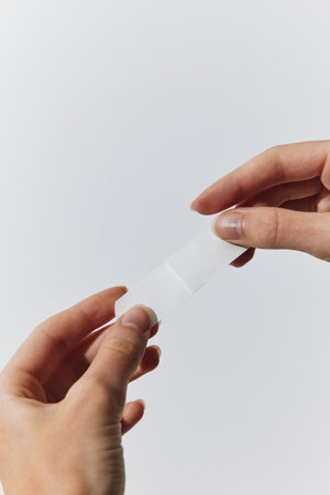 Hands holding paper against white background with copy spaceの写真素材