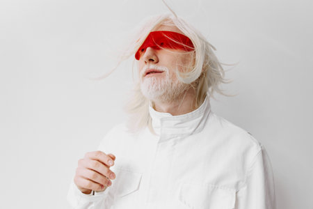 Futuristic man with white hair and red sunglasses on a bright white background, embodying a sci fi aesthetic Fashion forward with a unique style, exuding a modern vibeの写真素材