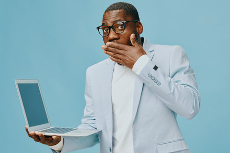 shocked, surprise, model, laptop, blue background, stylish outfit, expression, business attire, emotionの写真素材