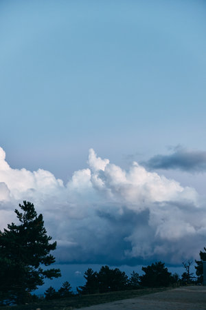 Scenic view of a peaceful blue sky surrounded by lush green trees