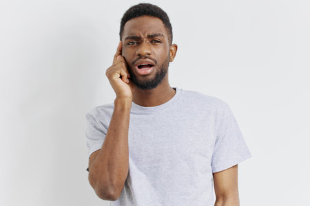 Curious man listening intently and observing something with focus on a white background