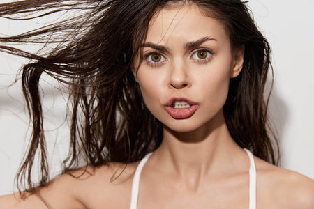 emotional expression, woman, hairstyle, close up shot, studio background, facial features, intense look, surprised face, beauty, portraitの写真素材