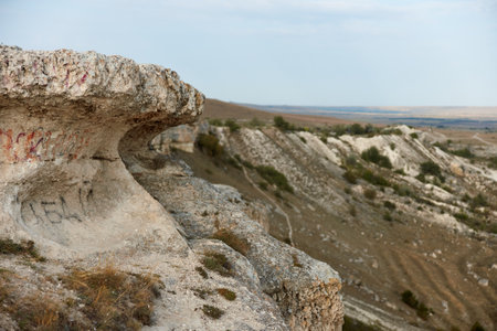 Majestic rock formations with person standing on cliff edge in beautiful landscape