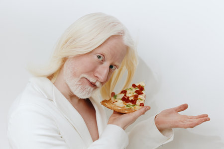 Gourmet pizza enthusiast presenting a colorful slice with toppings on a clean white background, showcasing joy and culinary delight in a modern settingの写真素材