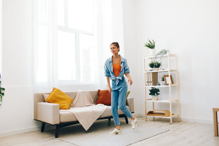 Joyful Woman Jumping and Dancing at Home: A Carefree Lifestyleの写真素材