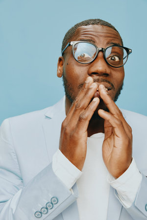 male model, surprise, excitement, casual attire, glasses, blue background, expressive emotion, hands...