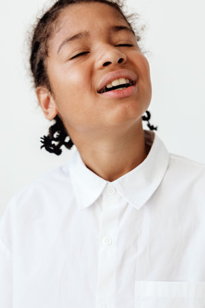 young boy in white shirt gazing at the sky with hope and wonderの写真素材