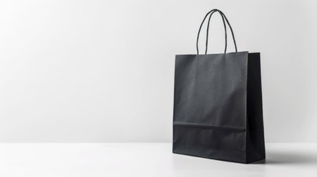Black shopping bag on a white background, elegant and minimalistic design perfect for retail or e commerce use The bag features strong handles and a clean finishの素材