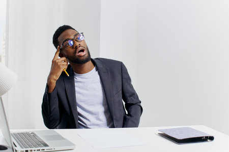 Business professional working at desk with laptop in office environmentの写真素材