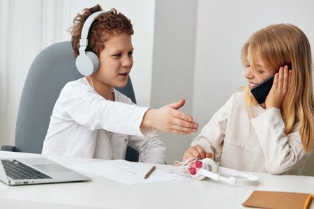 Studying Together at Home Boy and Girl Using Technology for ELearning A happy Caucasian brother and...