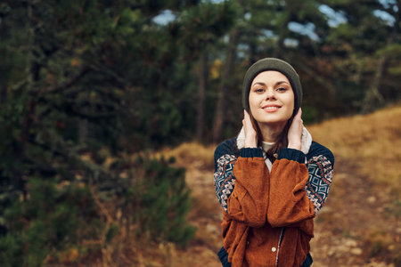 Beautiful young woman enjoying the autumn colors while exploring the serene beauty of the forest...