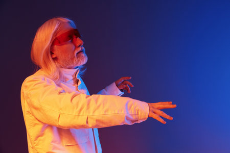 futuristic man with long white hair in white coat, reaching out against a blue and orange background, representing innovation and technology concepts creativelyの写真素材