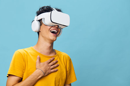 Virtual reality experience, happy young man wearing VR headset, blue background, engaging moment,...